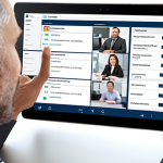 **Prompt:** A modern insurance brokerage office. Visualizes personalized CRM in action. Shows a broker interacting with a client on a tablet displaying customer data and policy history. Focus on organization, accessibility, and improved client relations.
